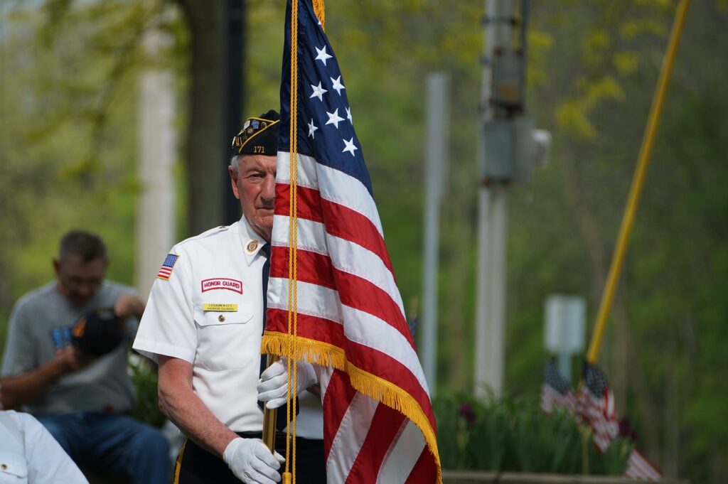 A military veteran holding a flag.